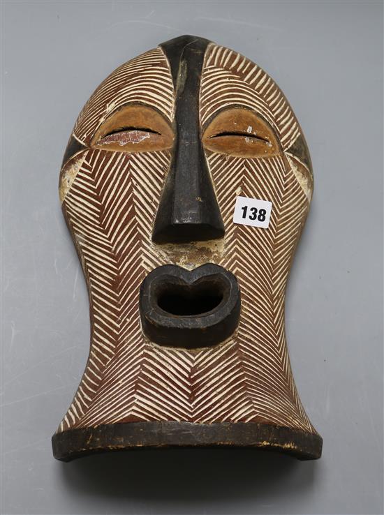 A Songye carved wood mask length 37cm